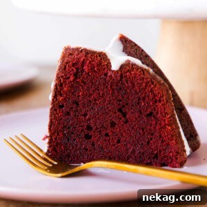 A side view of a slice of Red Velvet Pound Cake with Cream Cheese Glaze.