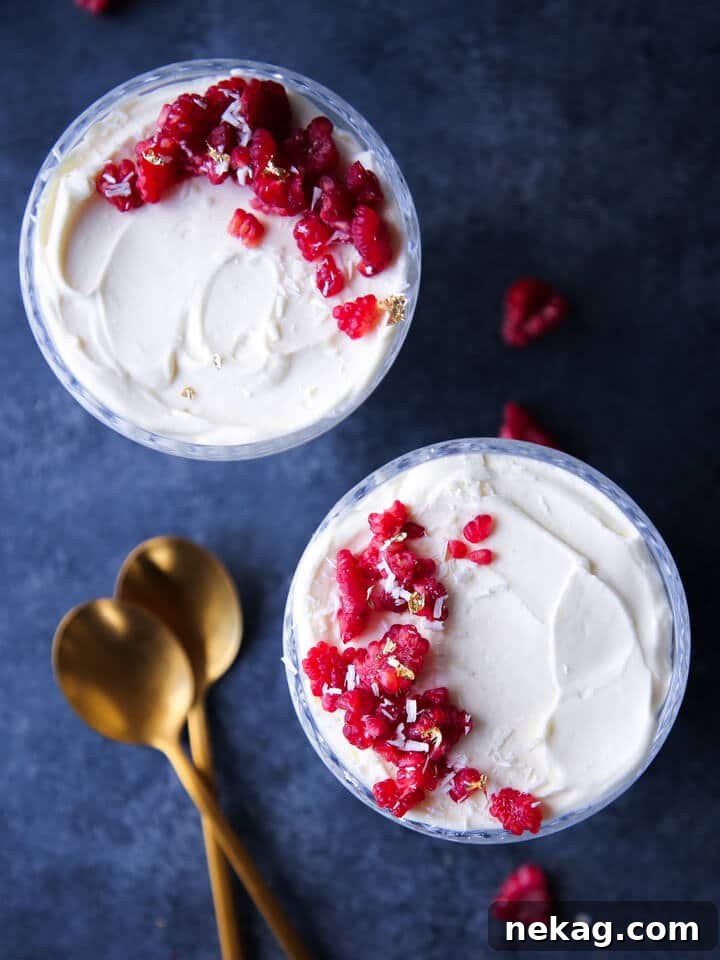 Two elegant coupes filled with White Chocolate Raspberry Mousse, an easy and sophisticated dessert for Valentine's Day.