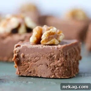 A sliced fudge square topped with a walnut.
