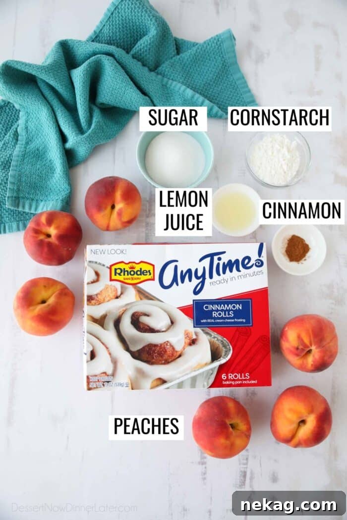 All the ingredients laid out on a kitchen counter for making Cinnamon Roll Peach Cobbler, featuring fresh peaches, sugar, cornstarch, lemon, cinnamon, and a box of Rhodes AnyTime Cinnamon Rolls.