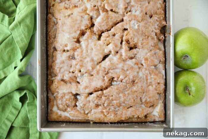 Cinnamon Apple Fritter Cake 10 A top-down view of the freshly glazed apple cinnamon cake resting in its 13x9-inch pan, showcasing the even glaze distribution.