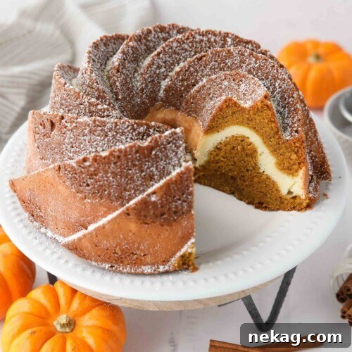 Spiced Pumpkin Bundt with Cream Cheese Swirl 11 Inside of pumpkin bundt cake with cream cheese filling, showing the distinct layers.