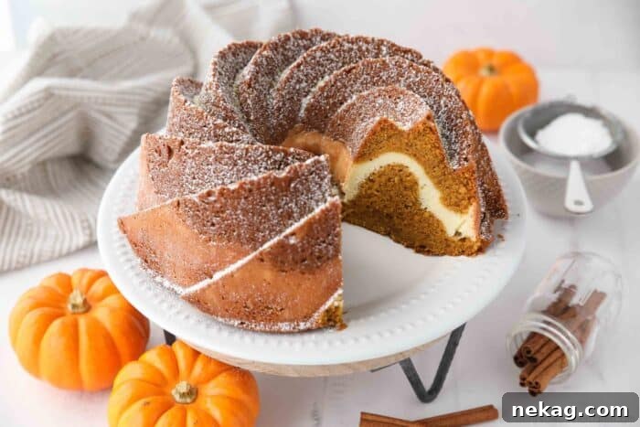 Spiced Pumpkin Bundt with Cream Cheese Swirl 9 The impressive interior of a Pumpkin Bundt Cake with Cream Cheese Filling, showcasing the intricate swirl and moist texture of both layers.