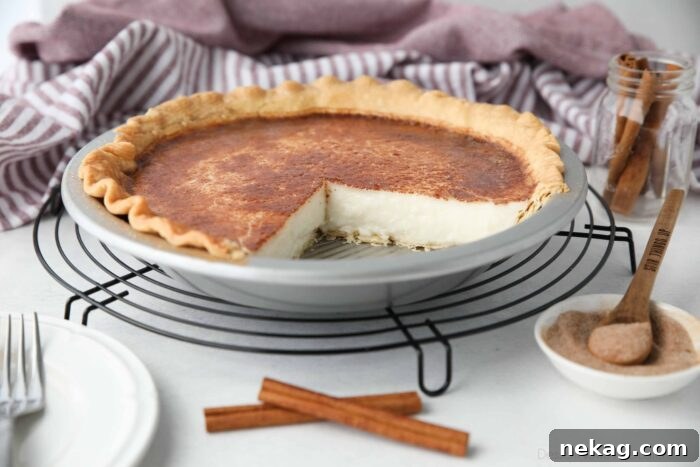 Homemade Sugar Cream Pie Recipe Video 7 A Hoosier Pie in its tin, showing the beautiful broiled topping with a slight caramelization, with two slices already removed.