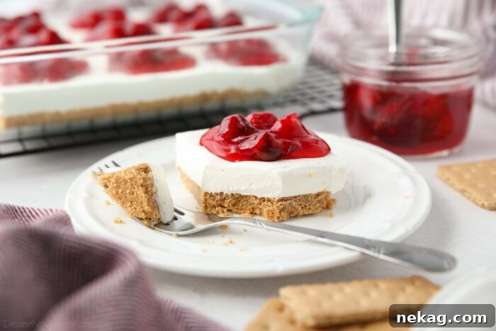 Crimson Cherry Bliss 8 Slice of Cherry Delight on a plate with a fork full taken out.