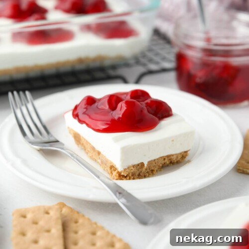Slice of cherry delight no bake cheesecake on a plate.