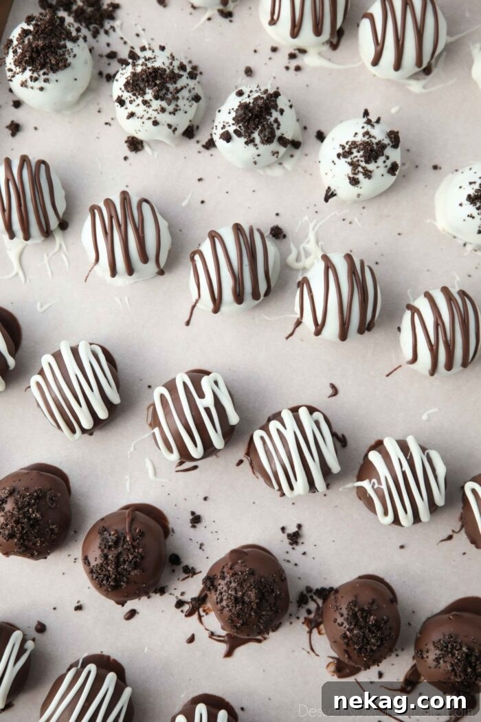 No Bake Oreo Truffles 3 Drizzled chocolate and crushed cookies on top of dipped Oreo Balls.