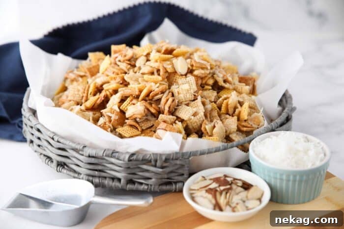 Close-up of Gooey Chex Mix with visible coconut and almonds, highlighting its sticky texture.