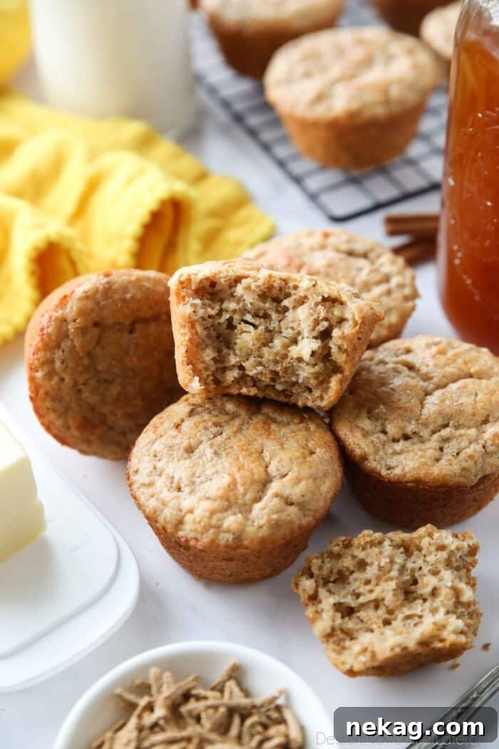 Wholesome Bran Muffins 2 Bran muffins with one cut open, showing the fluffy inside texture.
