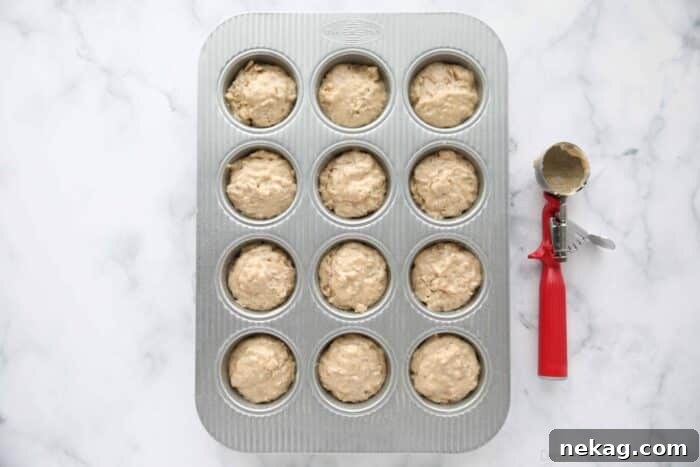 Wholesome Bran Muffins 9 Bran batter scooped into a muffin tray.