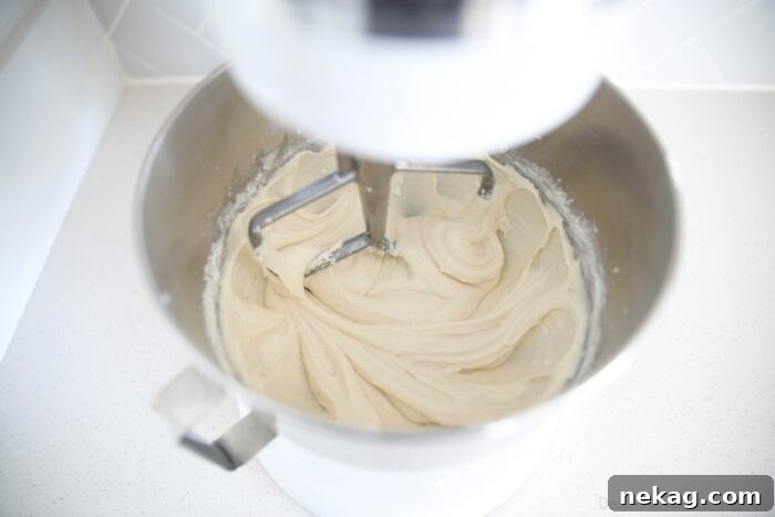 Perfectly Fluffy White Cupcakes 7 A bowl of smooth, thick white cake batter, perfectly mixed and ready for baking cupcakes.
