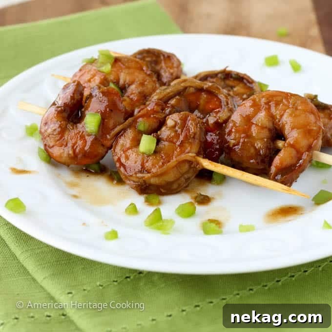 Zesty Grill Brew Prawns 8 Spicy Barbecue Beer Shrimp on a skewer being pulled from a bowl