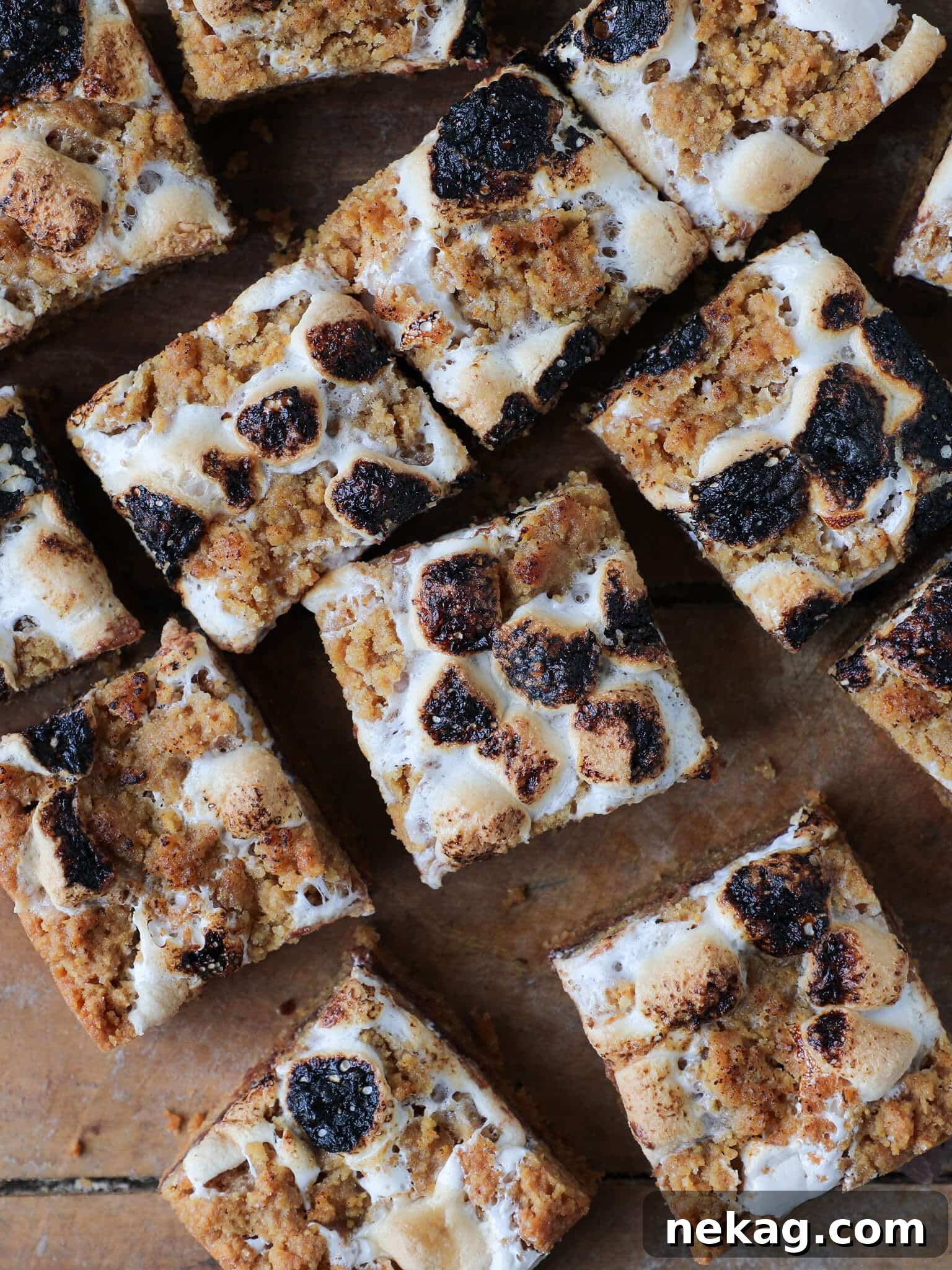 Soft Chewy S'mores Crumble Bars arranged artfully on a wooden surface