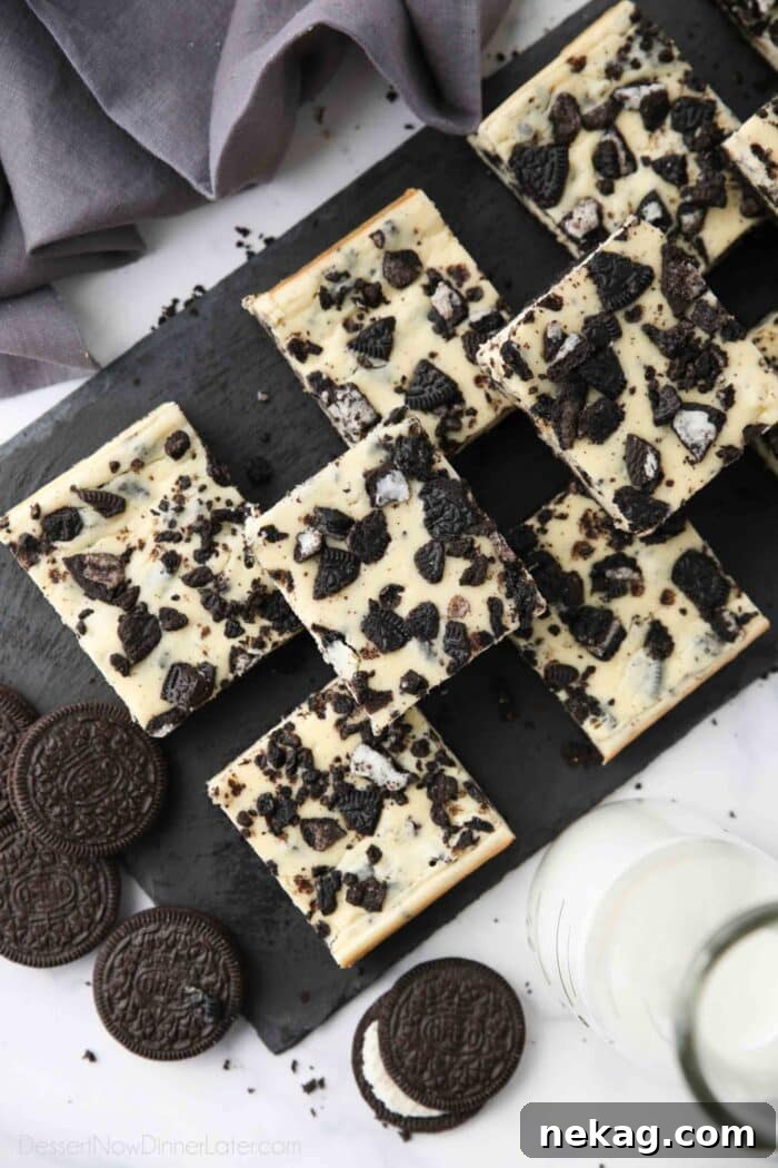 Oreo Crunch Cheesecake Bars 3 Top view of a platter filled with neatly cut squares of Oreo cheesecake bars.