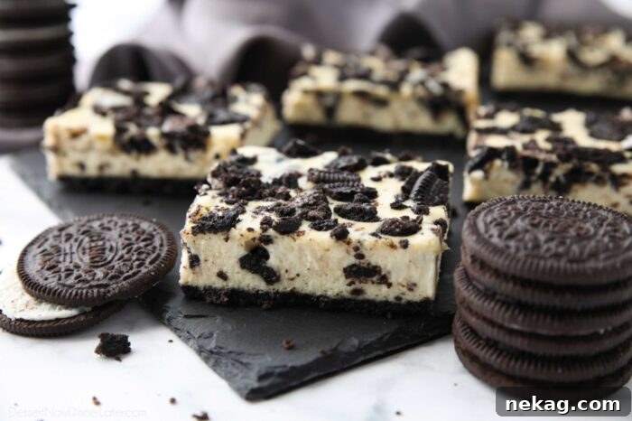 Oreo Crunch Cheesecake Bars 8 Close up of a perfectly sliced Oreo cheesecake bar, showing the distinct crust, filling, and topping.