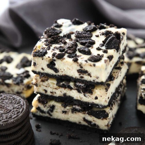 Three Oreo cheesecake bars stacked together.
