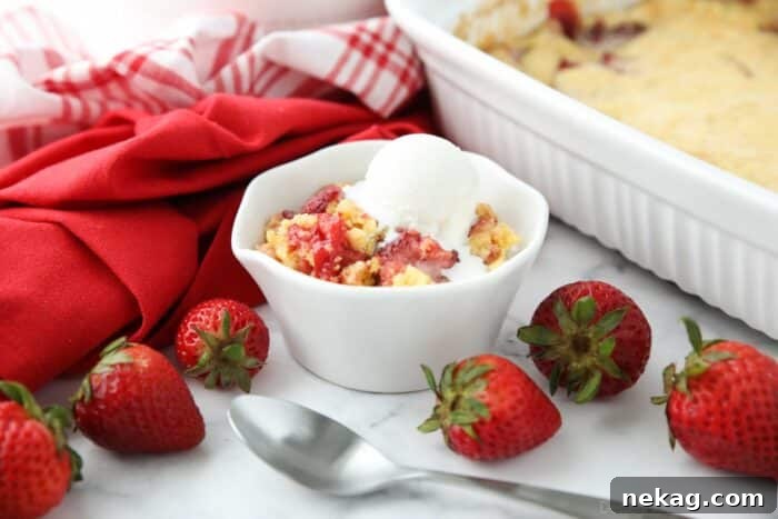 Effortless Strawberry Delight 9 Another enticing view of Strawberry Dump Cake served with vanilla ice cream, emphasizing its comforting appeal.