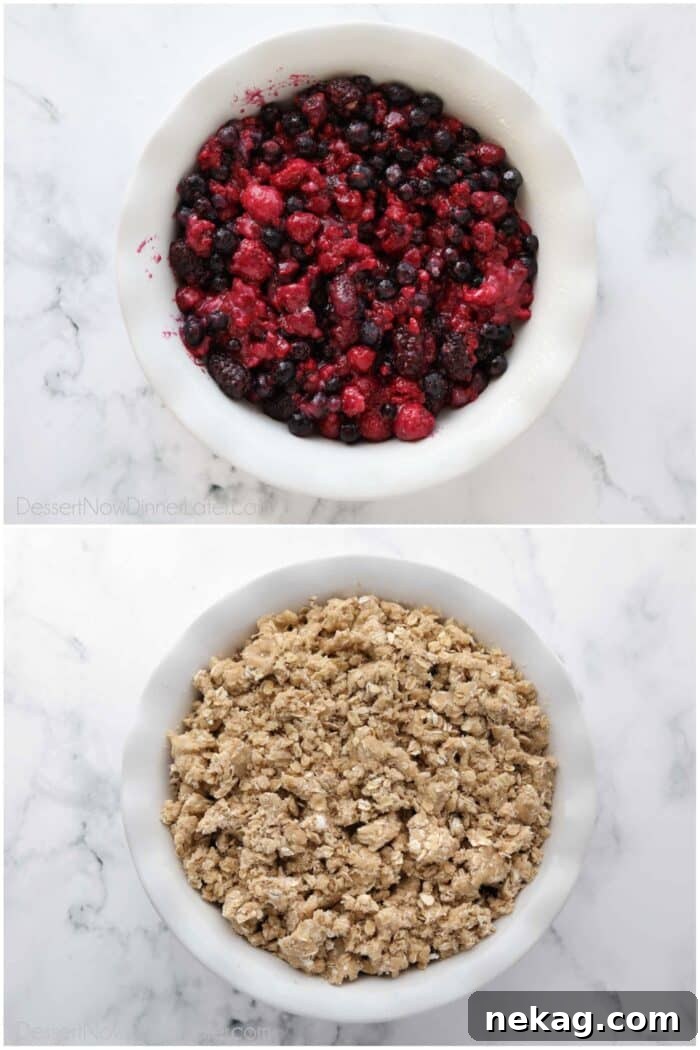 The process of making a berry crisp recipe, showing the berry mixture in a pan with the crumb topping being sprinkled over it.