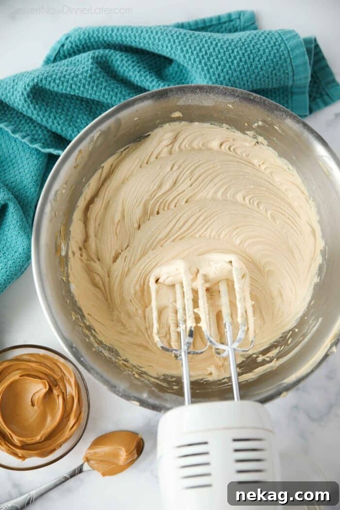 Velvet Peanut Butter Frosting 3 Bowl of peanut butter frosting made with an electric and mixer.