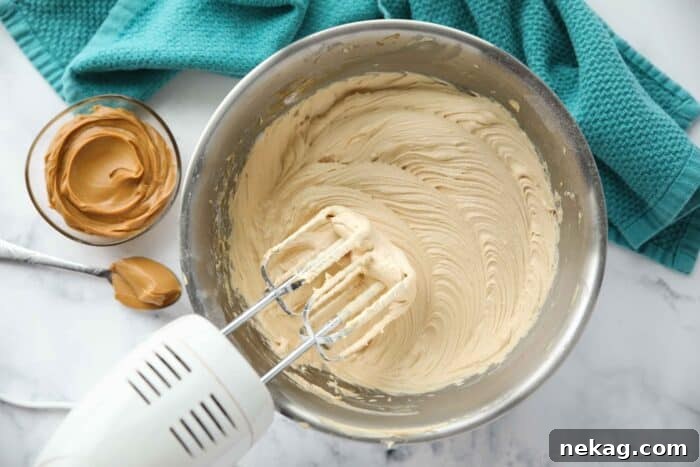 Velvet Peanut Butter Frosting 6 Bowl of peanut butter frosting made with an electric and mixer.
