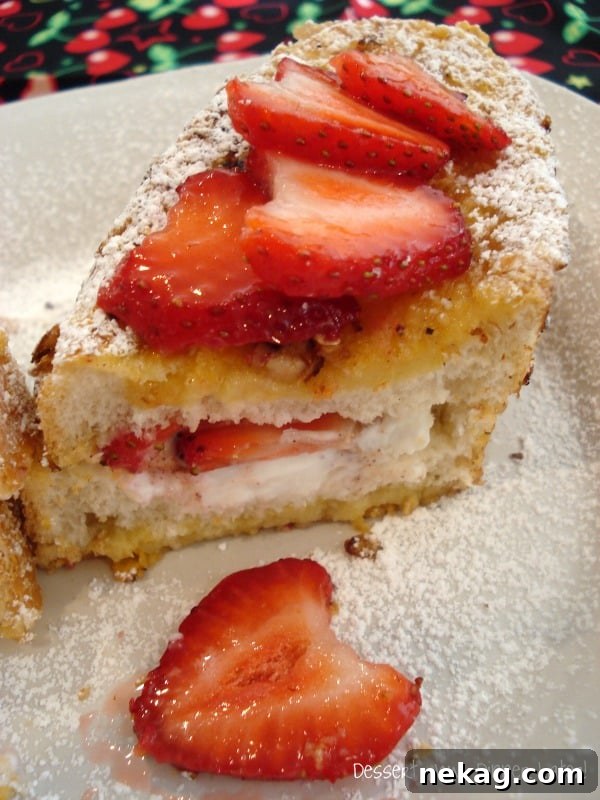 Close-up of Crispy Strawberry & Greek Yogurt Stuffed French Toast showing the fresh strawberry and yogurt filling.