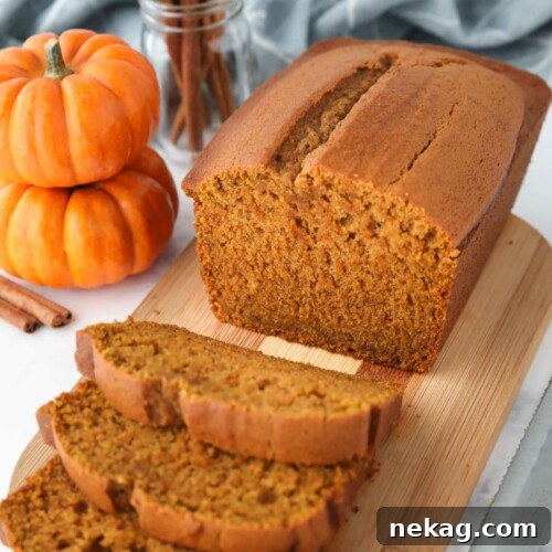 Delicious pumpkin loaf on a cutting board, sliced and ready to serve.
