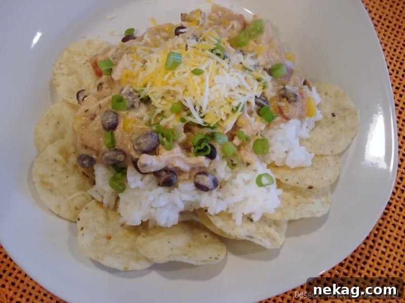 Close-up of a slow cooker filled with creamy Mexican Haystack mixture