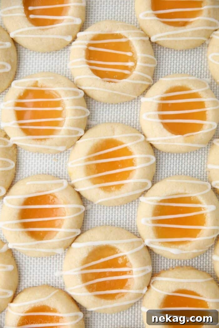 Tangy Lemon Delights 9 A close-up shot of a single perfectly baked shortbread cookie with a glistening lemon curd center, adorned with a delicate powdered sugar glaze drizzled artistically on top. The cookie's golden edge and vibrant yellow filling pop, making it an enticing treat.
