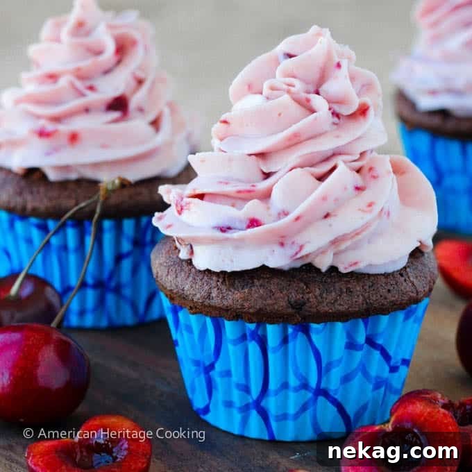 Velvet Chocolate Cherry Mascarpone Cloud Cupcakes 4 A row of expertly frosted Double Chocolate Cupcakes with Cherry Mascarpone, ready to be enjoyed.