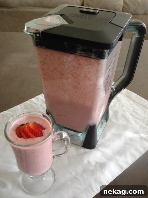 Strawberry Bliss Lassi 3 Strawberry Lassi in a clear glass, showing its creamy texture and pink color