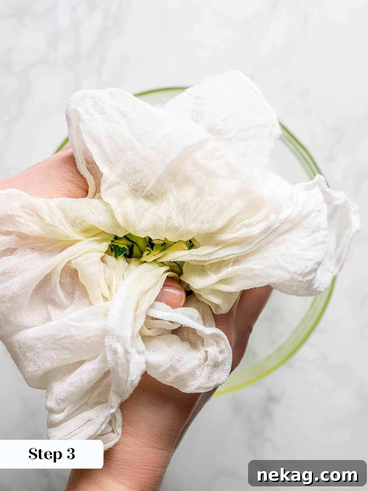 The crucial step of squeezing shredded zucchini in cheesecloth to remove excess moisture for crispy fritters.