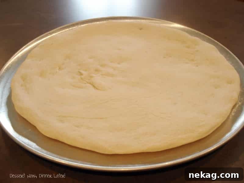 Simple Homemade Pizza Base 4 Easy Pizza Crust ready to be topped, showing a perfectly golden edge.