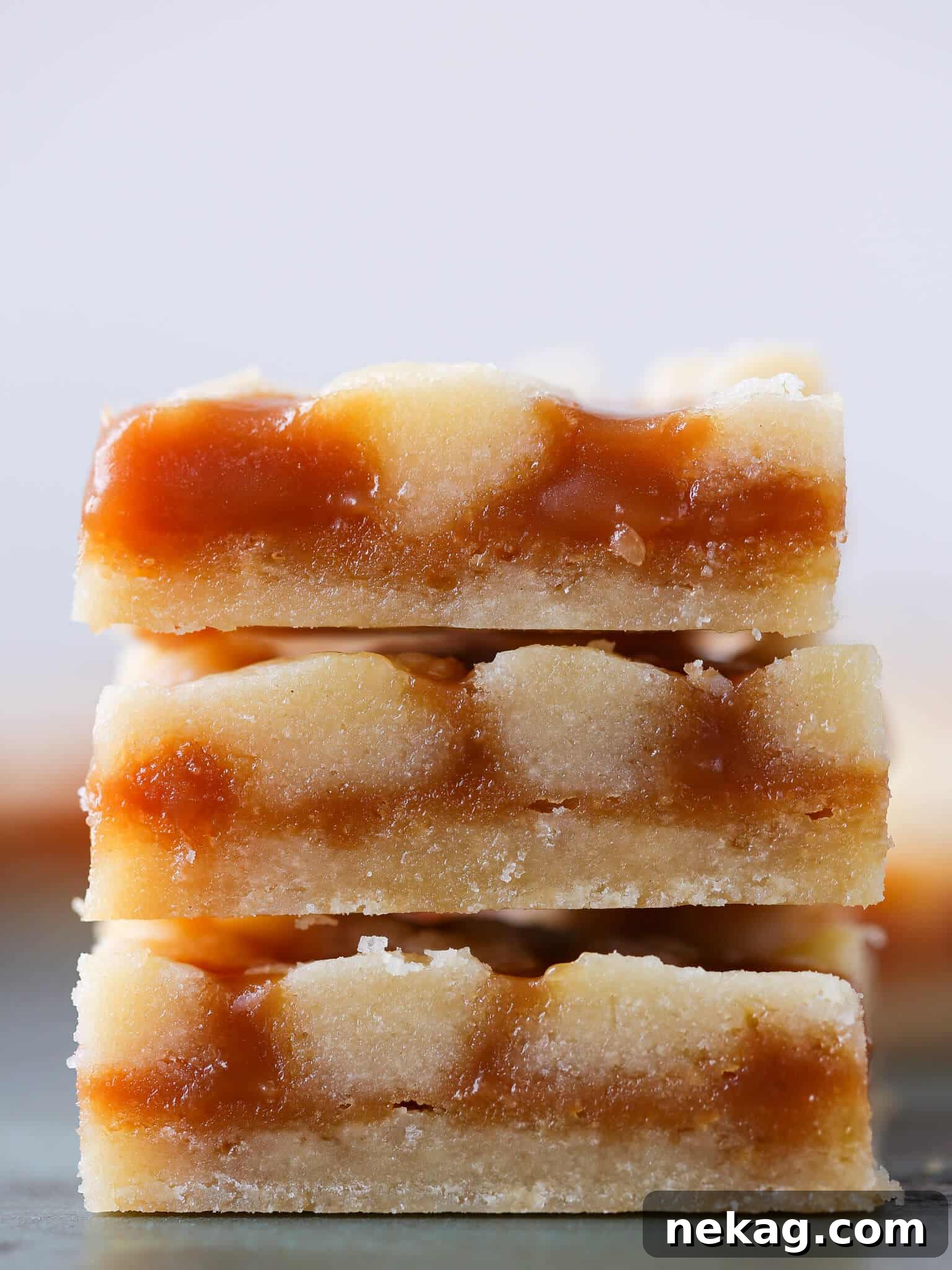 Stacked slices of Salted Caramel Butter Bars, showcasing their golden-brown top and gooey filling.