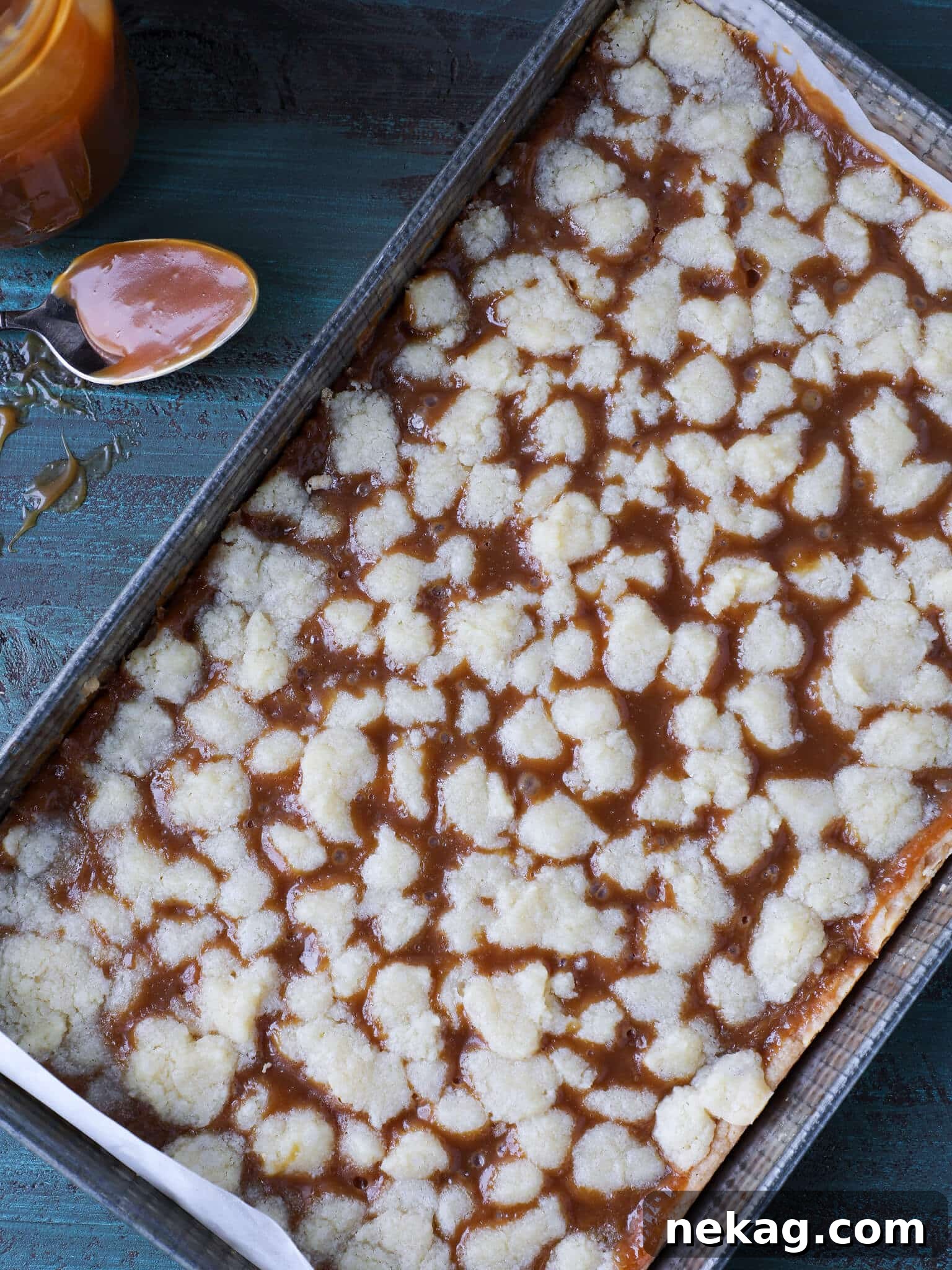 Uncut Salted Caramel Butter Bars cooling in a vintage baking pan, ready to be sliced.
