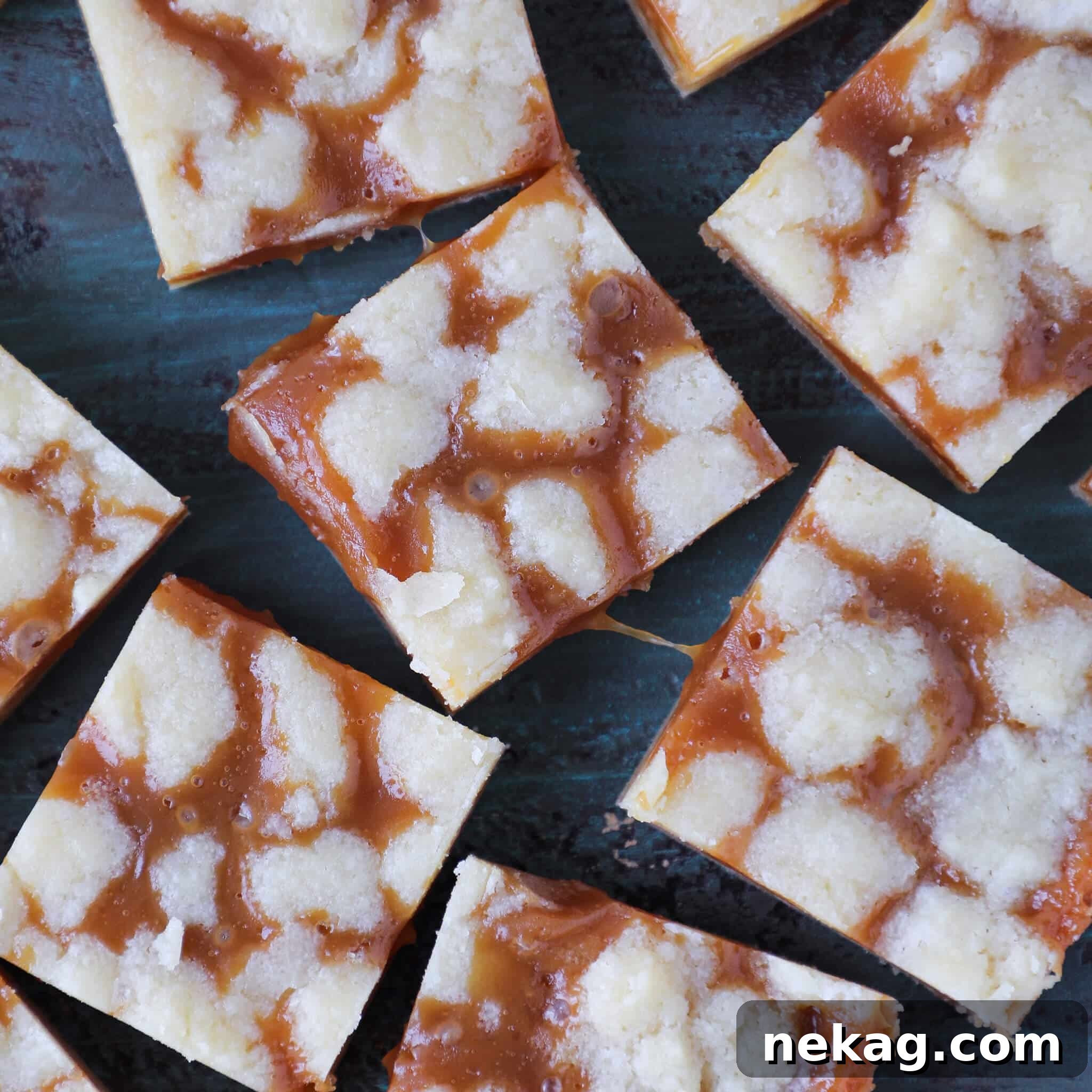 Salted Caramel Butter Bars cut into squares with a close-up showing the rich caramel filling pulling apart.