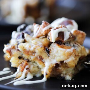 A close-up view of a perfectly baked slice of bread pudding, showcasing its moist interior and golden crust.