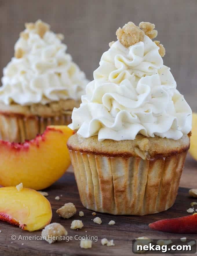 Delightful Peach Crisp Cupcakes filled with sweet peach compote and topped with luxurious Swiss meringue buttercream