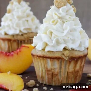 Peach Crisp Cupcakes filled with peach compote and topped with Swiss meringue buttercream