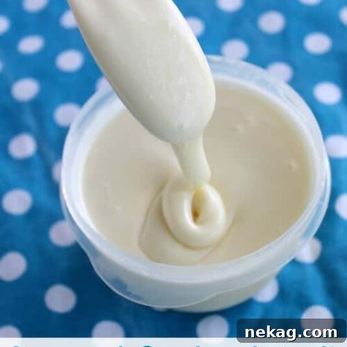 Sweetened Condensed Milk in a glass container with a spoon