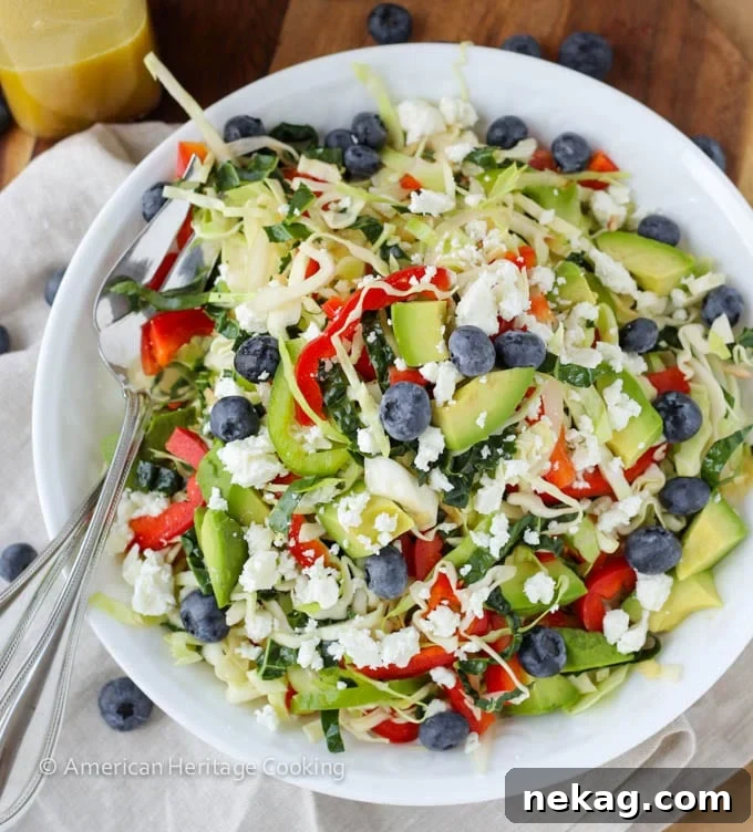 A large serving of Healthy Kale and Cabbage Slaw Salad with a fork