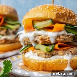 Ultimate Chicken Burgers 11 chicken burgers topped with white sauce and pickled veggies.