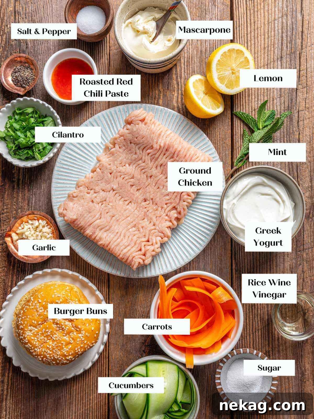 Ultimate Chicken Burgers 4 A collection of fresh chicken burger ingredients laid out on a wooden surface.