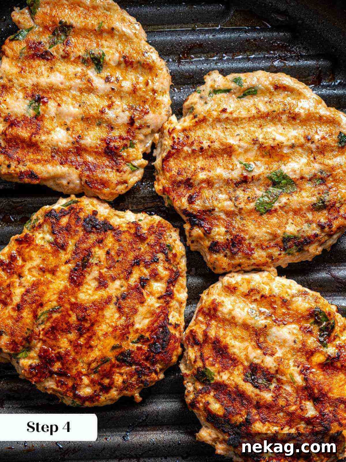 Ultimate Chicken Burgers 7 juicy chicken burgers sizzling in a hot grill pan, showing clear grill marks.