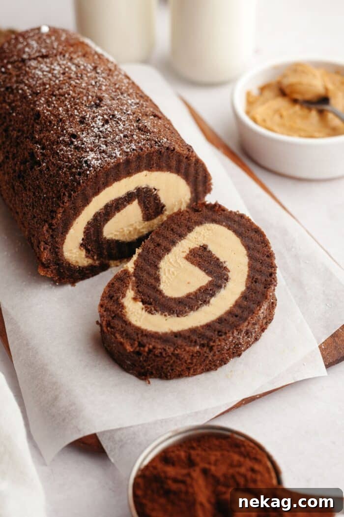 Velvet Chocolate Roulade 2 A slice cut off the end of a chocolate roll cake with peanut butter filling.