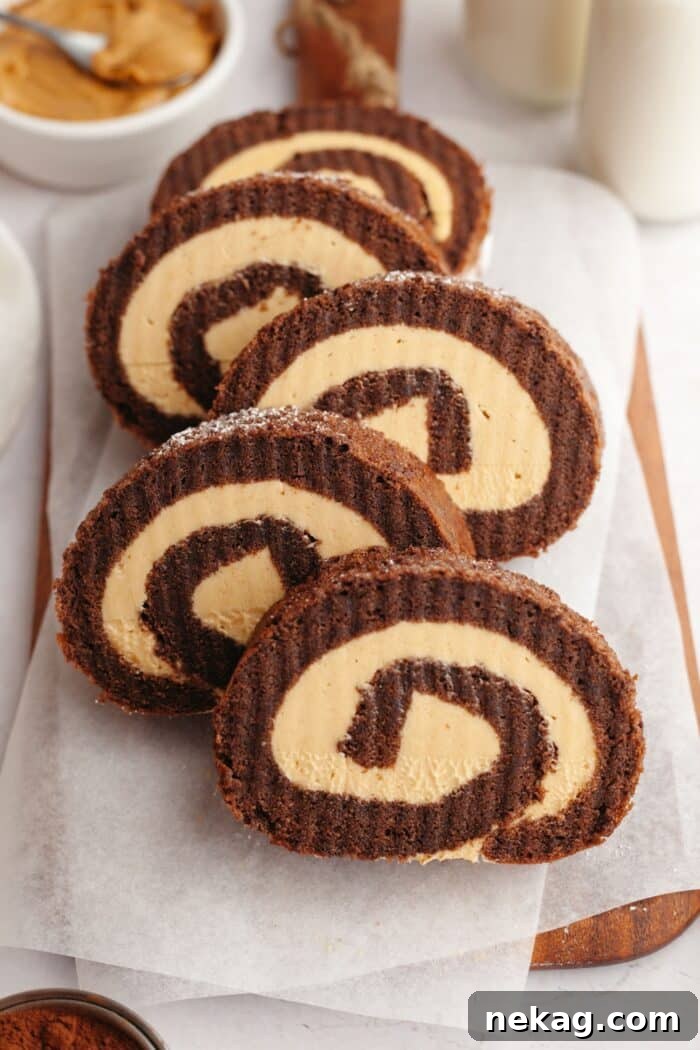 Velvet Chocolate Roulade 6 Slices of chocolate peanut butter cake roll staggered on a wooden cutting board.
