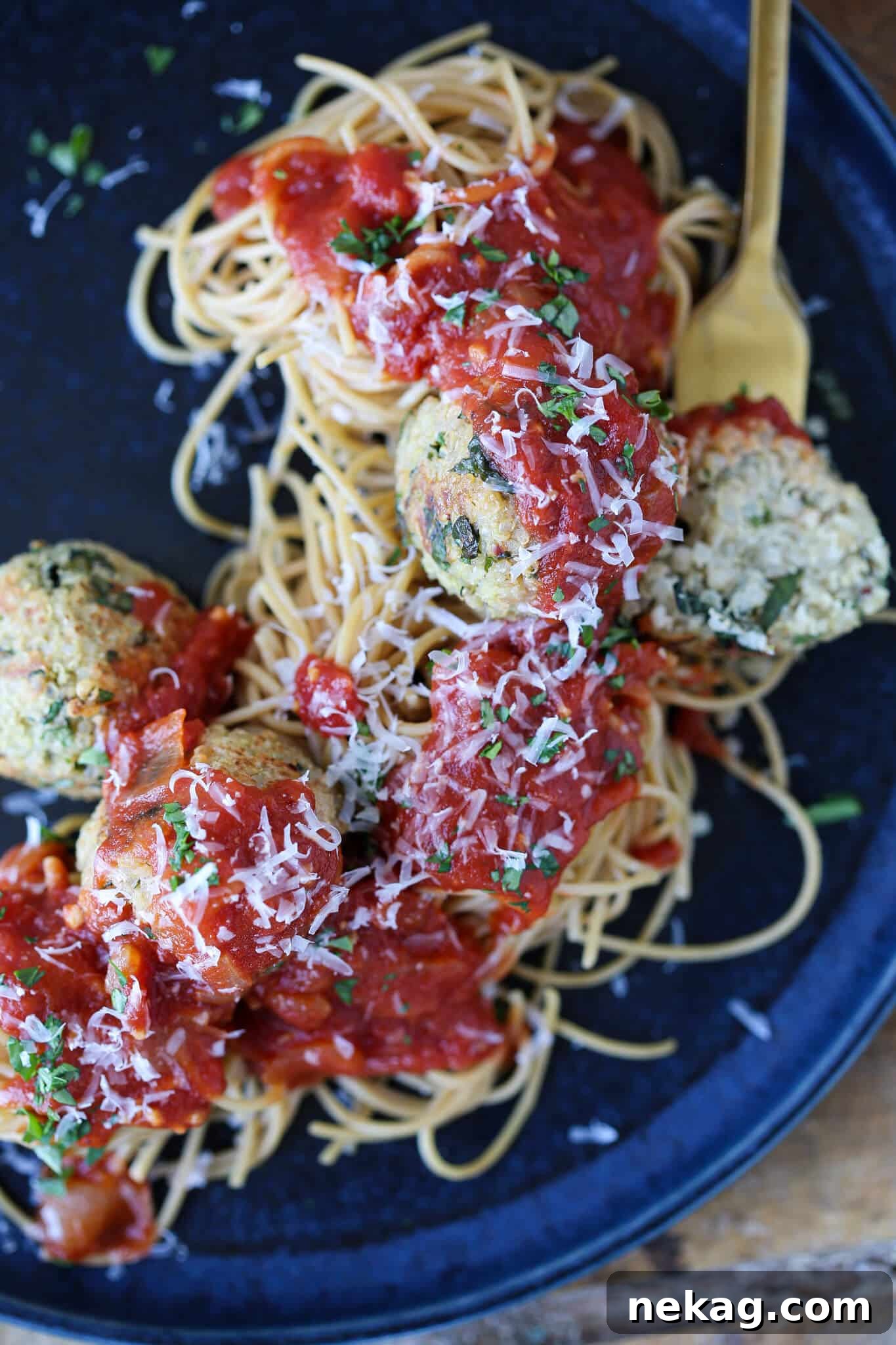 Wholesome Quinoa Veggie Meatballs 2 Quinoa Vegetarian Meatballs in sauce on pasta on blue plate
