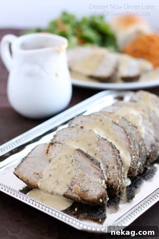 Succulent Pork Roast with Rich Pan Gravy, Sweet Potato and Apple Puree 3 Sliced savory pork roast drizzled with rich, homemade pan gravy, ready to be served.