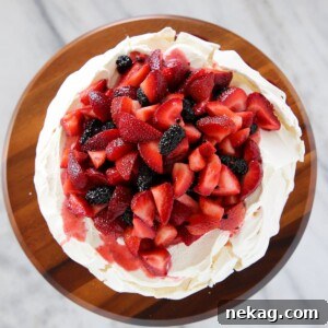 The best pavlova dessert with lemon curd and fresh fruit, a light and airy summer treat.