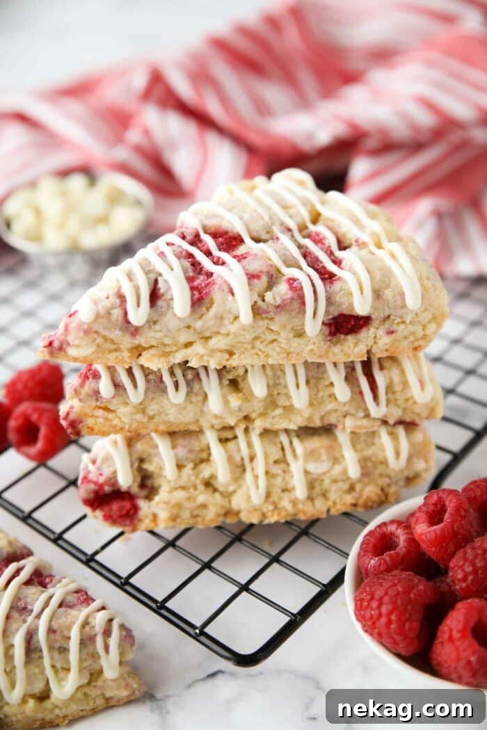 Indulgent White Chocolate Raspberry Scones 3 A stack of white chocolate raspberry scones.