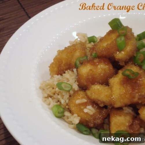 Baked Orange Chicken on a plate with rice and green onions